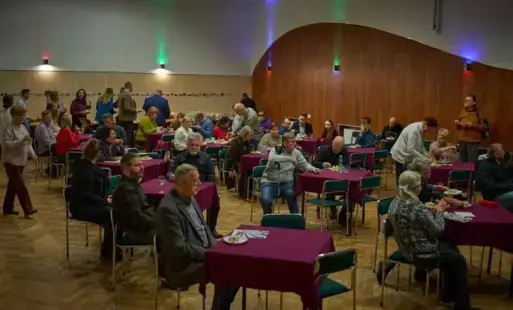 Ludzie siędzący przy stolikach w sali